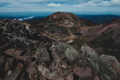 Aerial view of sea and mountains against sky