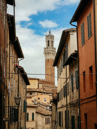 Low angle view of old buildings in town against sky