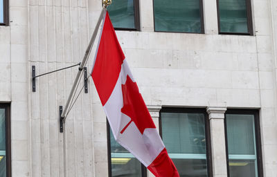 Canadian flag hanging on building