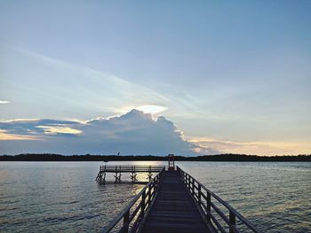 Pier over lake against sky