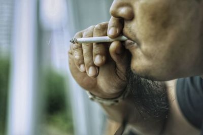 Close-up of man smoking cigarette