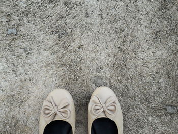 Low section of person standing on tiled floor