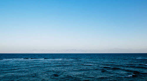 Scenic view of sea against clear blue sky