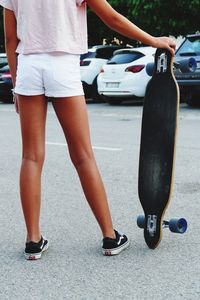 Low section of woman wearing high heels in city