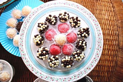 Directly above shot of sweet food served in plate on wicker table