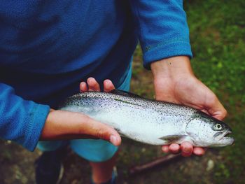 Close-up of man holding fish