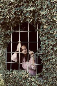 Portrait of woman against plants
