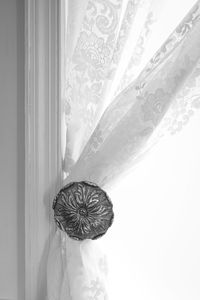 Close-up of decoration hanging against white wall