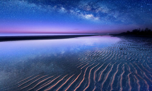 Scenic view of sea against sky at night