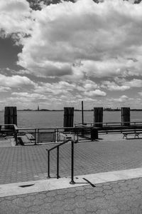 View of building by sea against cloudy sky