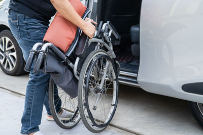 Midsection of man with bicycle