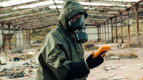 Man with geiger counter in radioactive site