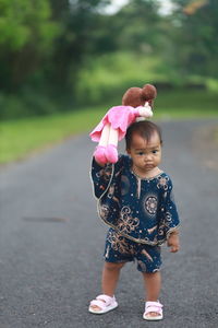 Low angle view of young woman holding flowers