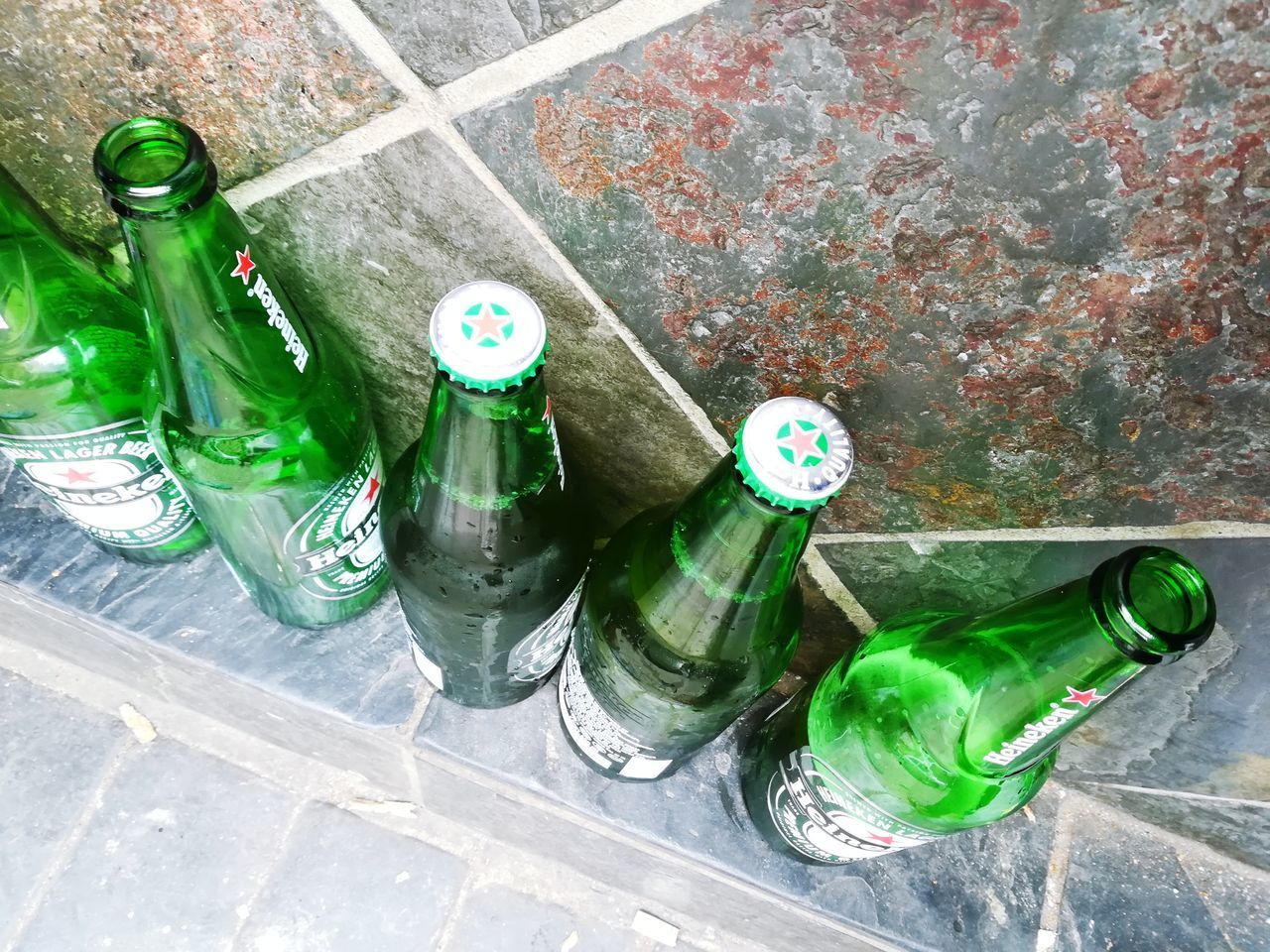 HIGH ANGLE VIEW OF BOTTLES IN CONTAINER