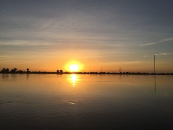 Scenic view of lake against sky during sunset