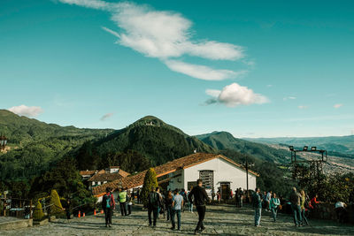 People on mountain against sky