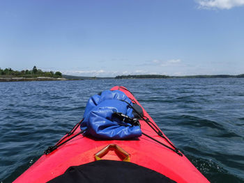 Kayak on sea against blue sky