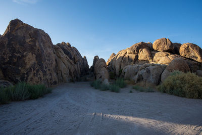 Rock formations on landscape against sky