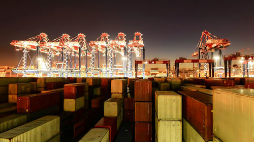 Illuminated commercial dock against sky at night