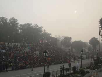 Crowd on tree against sky