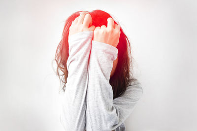 Close-up of woman against white background