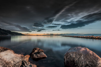 Scenic view of lake against sky during sunset