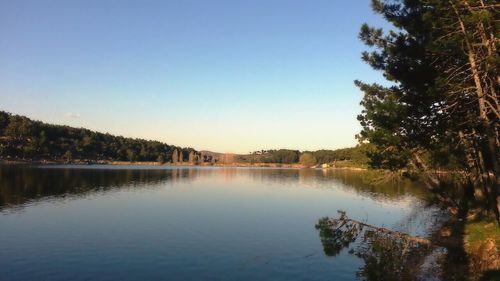 Scenic view of lake against clear blue sky