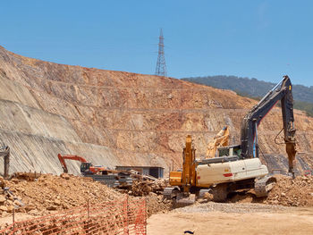 Construction site by road against sky