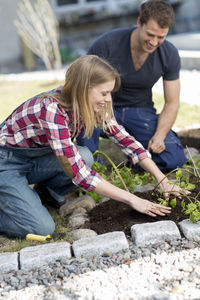 Young couple working in garden, stockholm, sweden