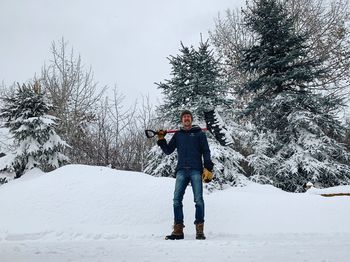 Full length of person standing on snow covered land