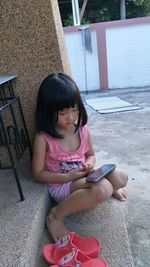 Cute girl sitting outdoors