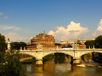 Arch bridge over river against sky