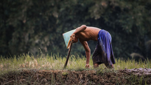Side view of man standing on field