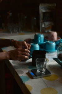 Midsection of person having food on table