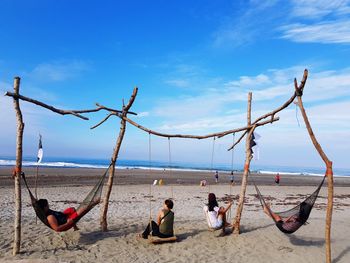 People on beach against sky