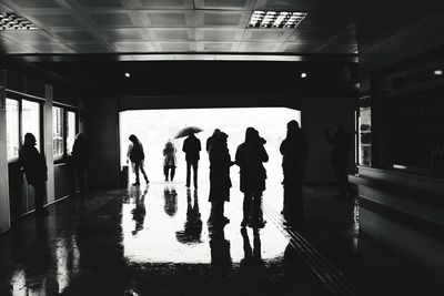 Group of people walking on railway station platform