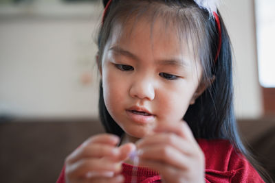 Close-up of cute girl making decoration