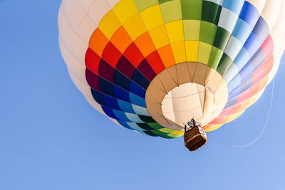 Low angle view of hot air balloon against clear blue sky