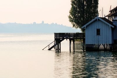 Scenic view of lake by building against sky