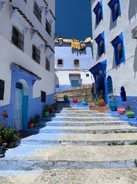 Low angle view of staircase amidst buildings in city