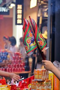 Close-up of hands holding food at market stall