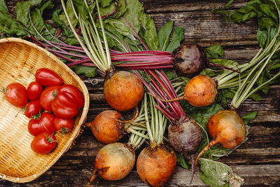 Vegetables. yellow and pink beetroots and red tomatoes on rustic wooden background