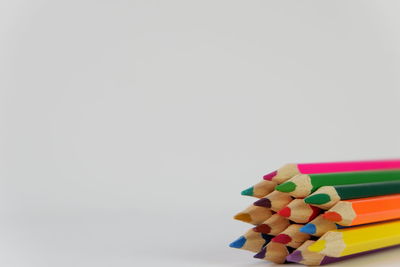 Close-up of multi colored pencils against white background