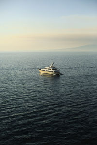 Boat sailing in sea against sky