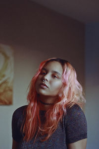 Portrait of young woman with dyed hair at home