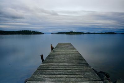 Pier over lake against sky