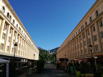 Low angle view of residential building against clear blue sky