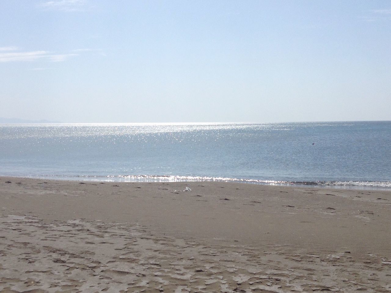 sea, beach, horizon over water, water, shore, sand, scenics, tranquil scene, tranquility, beauty in nature, copy space, clear sky, nature, sky, wave, idyllic, blue, day, outdoors, remote