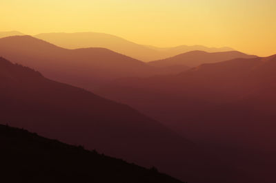 Scenic view of silhouette mountains against sky during sunset