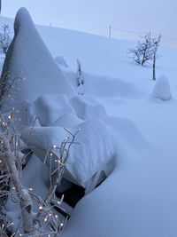 Snow covered landscape against snowcapped mountain